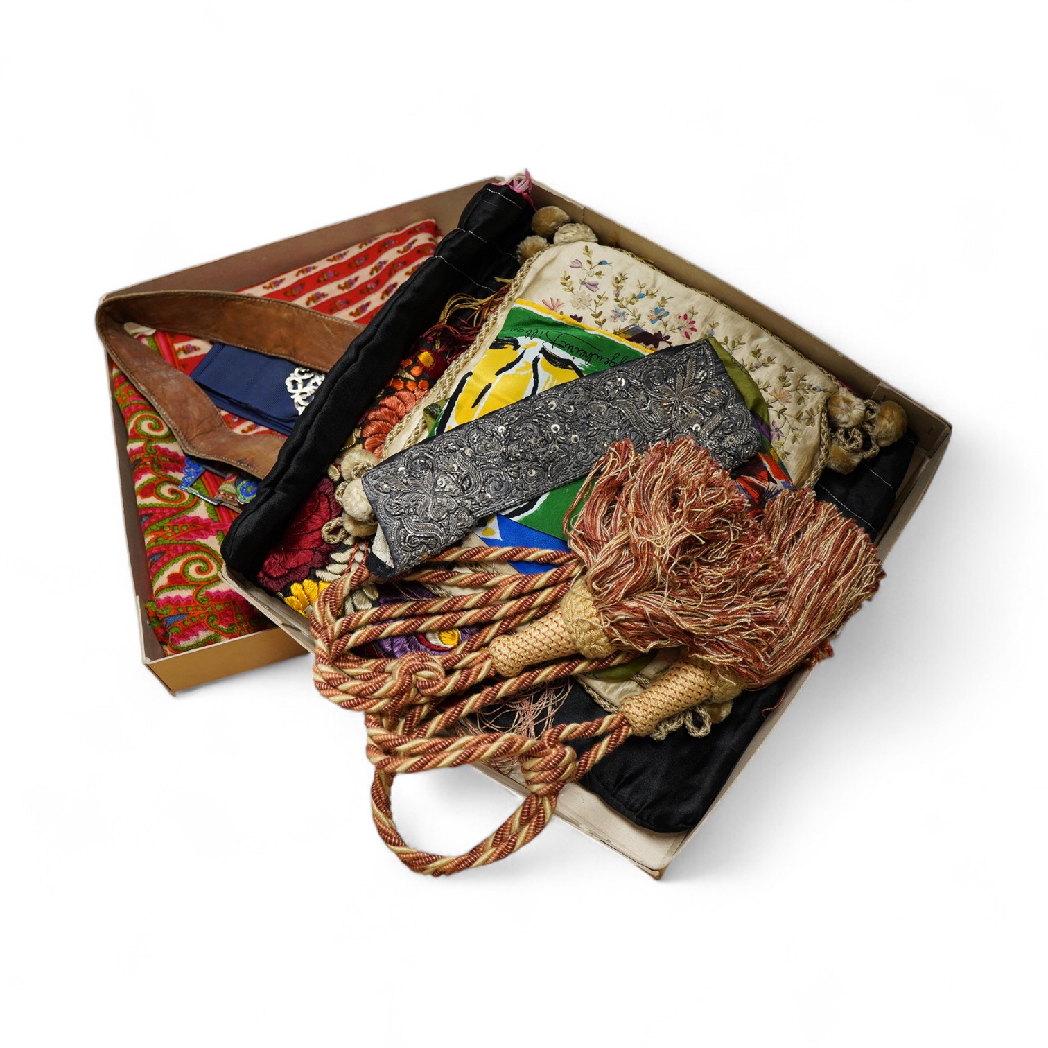 A collection of textiles: a ribbon work hankie and pyjama case, a metalwork collar, a coloured printed shawl, a nurses belt and embroidered belt, an advertising Guggenheim Bilbau hankie etc (10). Hankie case 22cm square.